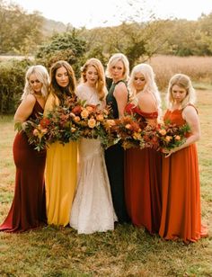 a group of women standing next to each other in front of a lush green field