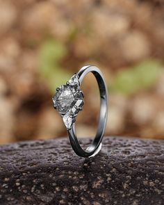 a diamond ring sitting on top of a rock