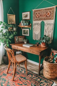 a desk with some plants and pictures on the wall