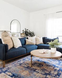 a living room with blue couches and rugs