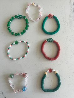 six bracelets are arranged on a white surface