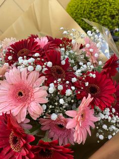 a bouquet of pink and red flowers in a vase