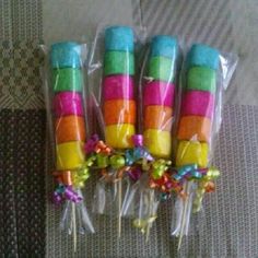 four colorful candy lollipops wrapped in plastic