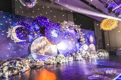 a stage set up for a show with lights and decorations on the floor, surrounded by balloons