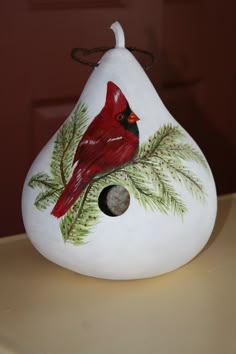 a painted rock with a cardinal on it