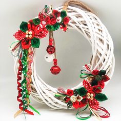 a white wreath with red and green decorations