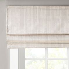 a white roman blind in front of a window