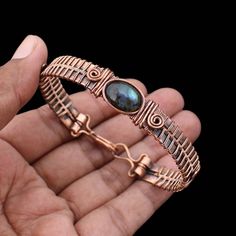 Labradorite Cuff Bracelet Copper Wire Wrapped Bangle Natural Labradorite Jewelry Gemstone Adjustable Bangle Handmade Wire Wrapped Jewelry Main Stone - Labradorite Bangle Length - 2.50 - 2.75" Inches (Adjustable) Bangle Width  -  0.50 Inches Metal                  -  Copper Copper Has Been Used For Jewelry Making For Thousands Of Years, Dating Back To Ancient Civilizations Such As The Egyptians, Romans, And Aztecs. Copper Was Valued For Its Beauty, Versatility, And Durability, And Was Often Used Artisan Labradorite Bracelets For Gifts, Adjustable Labradorite Bracelet With Unique Style, Handmade Labradorite Bohemian Bracelets, Handmade Labradorite Artisan Bracelets, Handmade Artisan Labradorite Bracelets, Spiritual Metal Bangle With Wire Wrapped Detail, Spiritual Wire Wrapped Metal Bangle, Spiritual Metal Wire Wrapped Bangle, Handmade Labradorite Bangle Jewelry