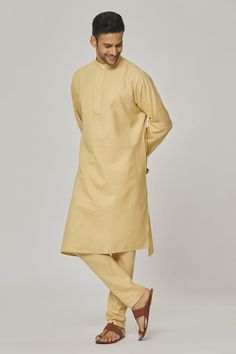 Dawn yellow cotton kurta with asymmetric hemline. Comes with pyjama.
Components: 2
Pattern: Solid
Neckline: Band collar
Sleeve Type: Full
Fabric: Cotton
Color: Yellow
Other Details: 
Closure : Kurta - Front buttons
Occasion: Mehendi and Puja - Aza Fashions Cotton Sherwani With Naqshi In Straight Kurta Style, Cotton Sherwani With Naqshi For Festivals, Cotton Sherwani With Naqshi For Diwali, Festival Cotton Sherwani With Naqshi, Cotton Salwar Kameez With Naqshi For Festivals, Festive Cotton Kurta With Naqshi, Naqshi Cotton Straight Kurta, Festival Cotton Salwar Kameez With Naqshi, Unstitched Cotton Churidar