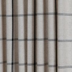 an image of a window curtain with grey and white plaid pattern on it's side