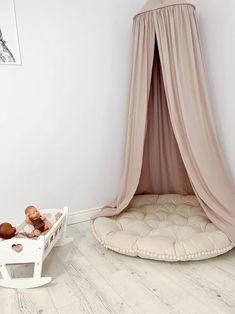 a child's room with a white rocking chair and canopy