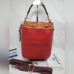 Coach Brand Signature Colorblock Leather Badge Field Bucket Bag Color:Red Multi Comes With 2 Removable Straps: Shorter Leather Strap 13" Longer Adjustable Strap 50" Beautiful Soft Leather Outside W/Interior Suede 1 Zip Pocket Inside Leather Cinch Closure Brass Hardware & Feet Comes With Dustbag Rectangular Travel Bucket Bag With Branded Hardware, Designer Satchel Bucket Bag With Branded Hardware, Designer Satchel Bucket Bag, Designer Rectangular Bucket Bag With Branded Hardware, Luxury Red Bucket Bag With Detachable Strap, Luxury Red Top Handle Bucket Bag, Designer Red Rectangular Bucket Bag, Luxury Red Bucket Bag With Adjustable Strap, Red Leather Bucket Bag