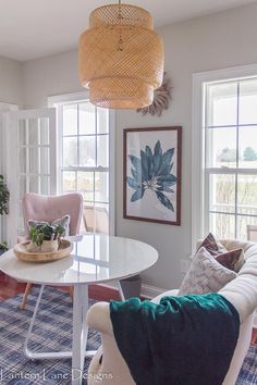 a living room filled with furniture and lots of windows