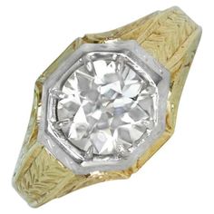 This exquisite Edwardian-era ring showcases a stunning 1.93-carat old European cut diamond, boasting K color and VS1 clarity. The diamond is securely set in prongs within an octagonal bezel, emphasizing its timeless beauty. The band is crafted in a unique combination of 14k white and yellow gold, adorned with delicate hand-engraved detailing that reflects the fine artistry of its circa 1910 craftsmanship. This antique piece radiates elegance and charm, making it a true testament to the refined j European Cut Engagement Ring, European Cut Diamond Engagement Ring, Edwardian Ring, Retro Era, European Cut Diamonds, Stone Cuts, Vintage Ring, Jewelry Rings Engagement, Hand Engraving