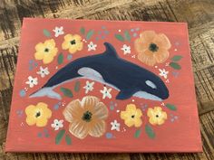 a painting of a dolphin and flowers on an orange background