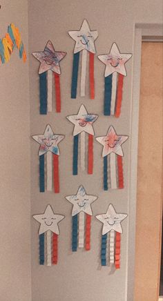 a bathroom decorated in patriotic colors with stars on the wall and paper streamers hanging from the ceiling