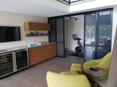 a living room filled with furniture and a flat screen tv mounted to the side of a wall