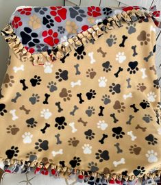 a dog themed blanket with paw prints on it