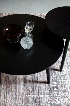 two black tables sitting on top of a carpeted floor