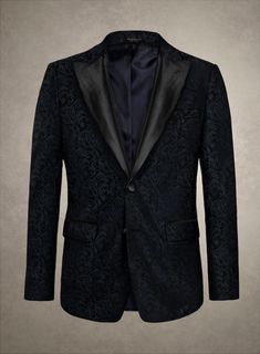 Experience the essence of luxury with our Italian Morbido Tuxedo Blazer. Masterfully tailored from premium polyester fabric, this distinguished piece is a testament to exquisite craftsmanship and sartorial elegance. As it adorns you, feel the embrace of its luxurious texture and the captivating charm it brings. The deep blue hue, enhanced with subtle yet captivating patterns, sets this blazer apart as an icon of style, transforming every appearance into an event of unparalleled sophistication. Ideal for gala evenings or exclusive gatherings, this versatile masterpiece adds a touch of class and refinement to your collection.  An elusive unique piece from our Red Carpet Collection.   Look features a 2 button tuxedo jacket with black cherry satin wide peak lapel, matching satin covered button Elegant Fitted Suit For Formal Occasions, Classic Custom-fit Blazer For Parties, Classic Party Blazer With Custom Fit, Elegant Custom Fit Suits With Hidden Button Closure, Elegant Custom Fit Suits For Formal Events, Classic Custom Fit Party Blazer, Classic Custom Fit Blazer For Party, Elegant Tailored Suit, Elegant Black Tuxedo With Lapel Collar