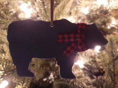 a black bear ornament hanging from a christmas tree