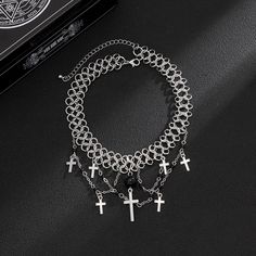 Description:Punk Layered Cross Tassel Collar Choker NecklaceSpecification:Size: 11.8" + 2.7" extWeight: 1.07 oz/pcsMaterial: alloy metal. glass seed beadChain colors: silverFeatures & Details:This punk style cross tassel collar choker necklace is made of nickel-free. lead-free. cadmium-free and hypoallergenic materials. which will not turn your skin green or cause anaphylactic reaction.It is easy to match your different outfits and also suitable for any occasions like wedding. banquet. costume p Punk Alloy Jewelry For Halloween, Halloween Metal Necklace With Adjustable Chain, Metal Chain Choker For Festivals, Punk Metal Choker For Halloween, Halloween Adjustable Chain Choker, Punk Style Silver Choker For Festivals, Punk Alloy Choker Necklace, Trendy Metal Choker For Halloween, Metal Chain Dangle Choker