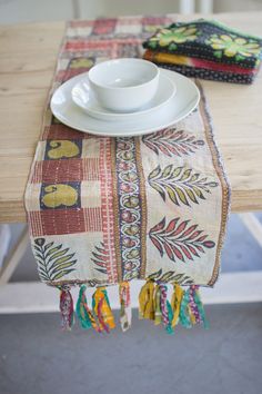 a place setting with plates and napkins on a wooden table