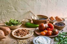 a table topped with lots of different types of vegetables and food on top of it