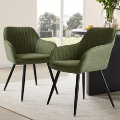 two green chairs sitting next to each other on top of a white carpeted floor