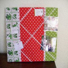 an altered photo album with red, green and white papers on it's cover