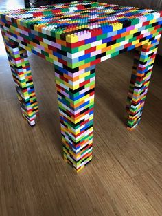 a table made out of legos on top of a hard wood floor in a living room