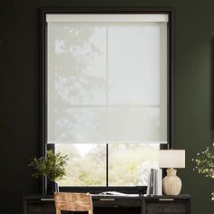 a desk with a chair and lamp in front of a window that has blinds on it