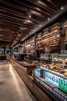 the interior of a deli filled with lots of food and drink bottles on display