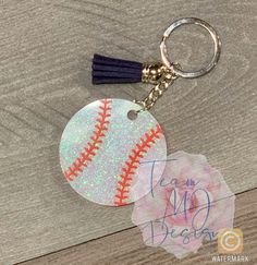 a keychain with a baseball on it and a name tag attached to it