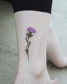 a small flower tattoo on the ankle