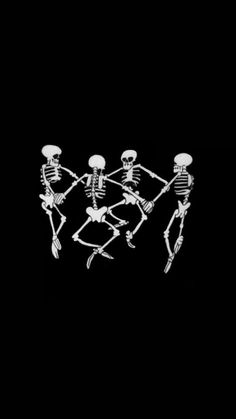 three skeletons playing with each other in the dark