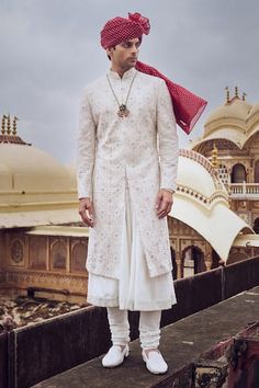 Ivory sherwani with beads, sequin and thread embroidery in geometric pattern. Paired with choga and churidar. - Aza Fashions Wedding Nehru Jacket With Mirror Work, Fitted White Nehru Jacket With Mirror Work, Festive White Nehru Jacket With Mirror Work, Designer White Sherwani With Mirror Work, White Sherwani With Mirror Work For Eid, Designer White Bandhgala With Mirror Work, Nehru Jacket With Mirror Work For Wedding Eid, Eid Wedding Nehru Jacket With Mirror Work, Elegant White Bandhgala With Mirror Work