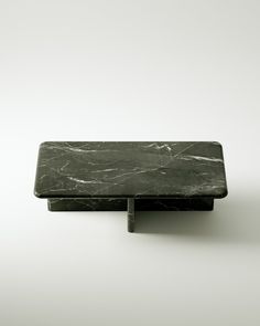 a black marble tray sitting on top of a white table