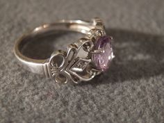 I am offering you this spectacular vintage sterling silver ring. This piece is stunningly beautiful with the following features: * Large oval amethyst dominates this ring * Individually set stone with four prongs and small round diamonds accent the center stone * beautiful cut away wide band and scrolling pattern * ring size 8 This is a classic piece with many fine features. There is tons of sparkle and shine with this piece. Buyer pays all shipping and handling. Vintage Silver Amethyst Ring With Accent Stones, Vintage Silver Amethyst Ring Birthstone, Vintage Amethyst Ring With Accent Stones For Anniversary, Vintage Oval Amethyst Ring For Wedding, Vintage Oval Amethyst Wedding Ring, Antique Amethyst Ring Stamped 925 For Anniversary, Vintage Silver Amethyst Ring For Anniversary, Silver Oval Heirloom Birthstone Ring, Heirloom Style Oval Amethyst Sterling Silver Ring