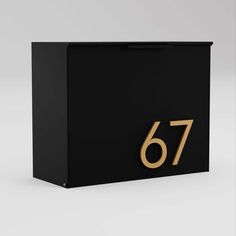 a black box with gold numbers on the front and bottom, that reads'76 '