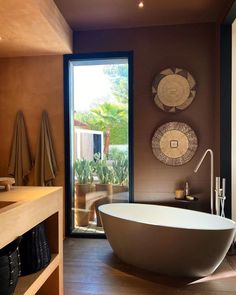 a large bath tub sitting next to a bathroom window