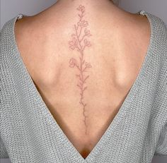 a woman with a flower tattoo on her back