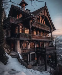 a large wooden house with lots of windows and balconies