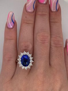 a woman's hand with pink, blue and white manicures on it