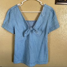 New With Tags, Never Used. Size S But Also Might Fit M Because It’s Stretchy Smocked From The Back. Thick Denim Material Denim Blue Short Sleeve Blouse For Day Out, Spring Washed Blue Blouse For Day Out, Summer Denim Blue Chambray Blouse, Denim Blue Denim Blouse For Summer, Summer Chambray Blouse In Denim Blue, Denim Blue Chambray Blouse For Summer, Denim Blue Summer Blouse For Day Out, Medium Wash Short Sleeve Summer Blouse, Medium Wash Short Sleeve Blouse For Summer