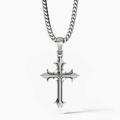 a unique sterling silver cross necklace hangs from a chain Classic Sterling Silver Cross Charm, Classic Engraved Crucifix Cross Necklace, Symbolic Sterling Silver Cross Pendant, Symbolic Sterling Silver Cross Pendant Jewelry, Sterling Silver Cross Pendant Symbolic Jewelry, Sterling Silver Oxidized Crucifix Necklace, Oxidized Sterling Silver Cross Pendant Necklace, Silver Symbolic Cross Necklace, Spiritual Polished Cross Jewelry And Charms