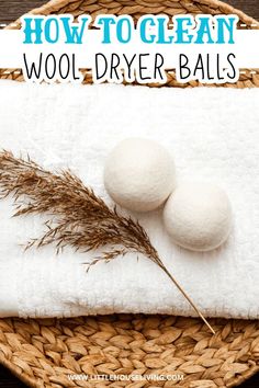 two wool dryer balls sitting on top of a white towel next to a plant