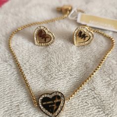 Rhinestones Surround This Pretty Heart Slider Bracelet, Logo Engraved, Adjustable Length. Earrings: Matching Post Earrings. Comes In Brand Box. Elegant Heart-shaped Metal Jewelry Sets, Elegant Michael Kors Metal Jewelry, Michael Kors Formal Metal Jewelry, Formal Michael Kors Metal Jewelry, Gold Crystal Heart Bracelets, Gold Heart Crystal Bracelets, Michael Kors Luxury Yellow Gold Jewelry, Gold Heart-shaped Crystal Bracelets, Bracelet Logo