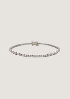 Popularized by famous tennis player Chris Evert in 1987 during the US Championships, the tennis bracelet is a timeless classic—then, now, always.Featuring 1.5mm round diamonds, four-prong cupcake set in 14k yellow or white gold. Wear alone or stacked with our Capri Curb Chain Bracelet. Designed and created in Los Angeles with ethically and sustainably sourced diamonds.Price is determined by bracelet length due to diamond quantity.Features a box clasp with safety for secure closure. The white gol Classic Platinum Tennis Necklace With Brilliant Cut, Classic Diamond Tennis Bracelet With Accents, Classic Platinum Tennis Necklace With Single Cut Diamonds, Classic Platinum Tennis Necklace With Prong Setting, Classic Round Cut Tennis Necklace With Prong Setting, Classic Platinum Diamond Bracelet With Single Cut Diamonds, Classic Tennis Necklace With Prong Setting, Timeless Platinum Jubilee Tennis Bracelet, Classic White Gold Tennis Necklace With Prong Setting