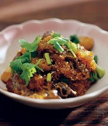 a white bowl filled with food on top of a wooden table